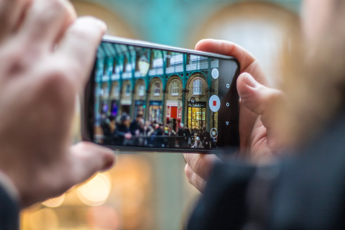 The person using a phone to shoot a video