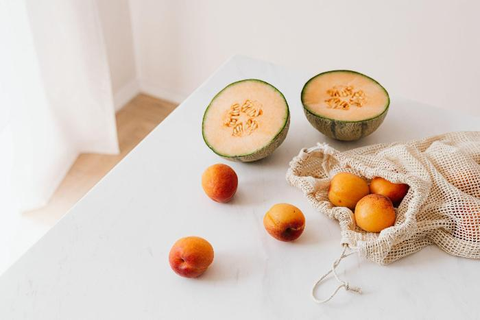 A still-life photo of fresh fruit on a white table