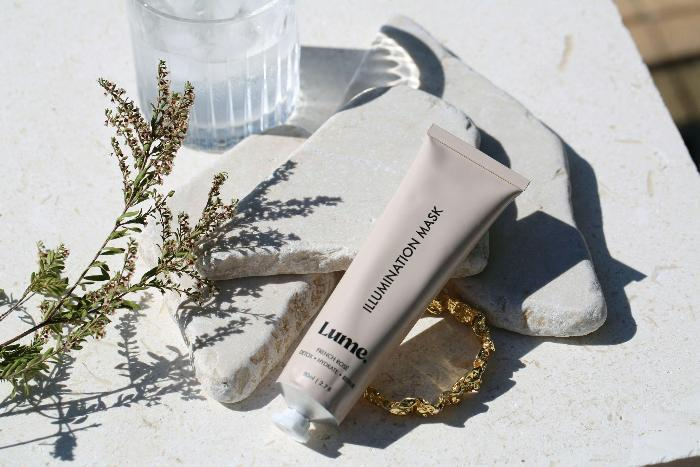 Skincare tube with plant, stone, shadow, natural sunlight