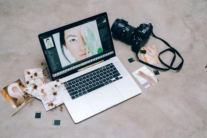 Laptop with photo editing software, DSLR camera, memory cards