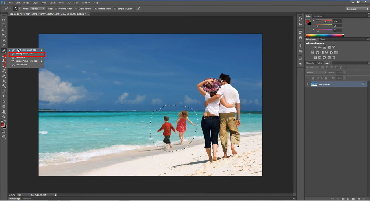 Using the healing brush tool to remove a person from a photo in Photoshop