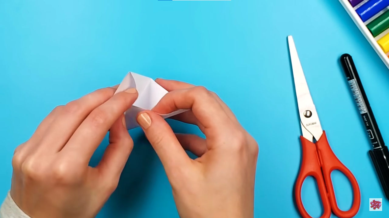 How to make a bookmark easy: fold the top corners into the triangular pocket