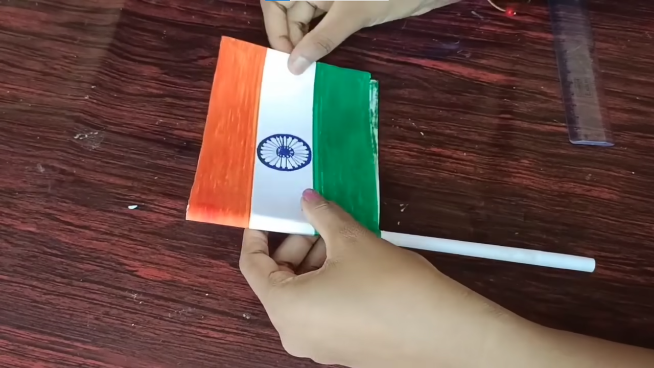 Glue the pole to your design to create own flag